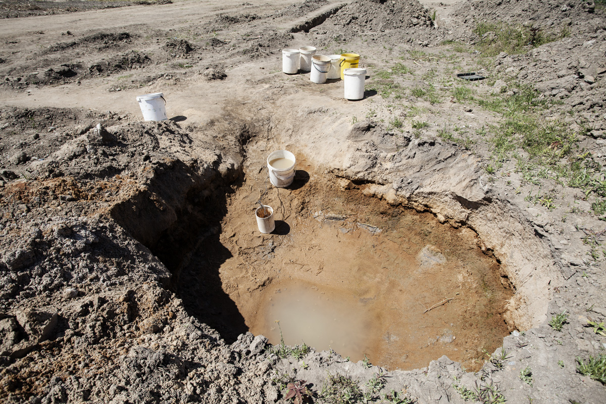 One of the holes that the women use to get water from under ground is almost dried up.