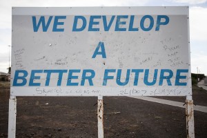 An Asla Construction sign with graffiti on it. Asla is the construction company that builds RDP houses in the Western Cape.